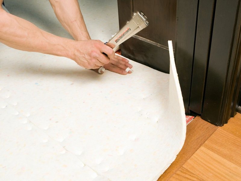 closeup of person installing underlayment - Rickway Carpet in North Mankato, MN